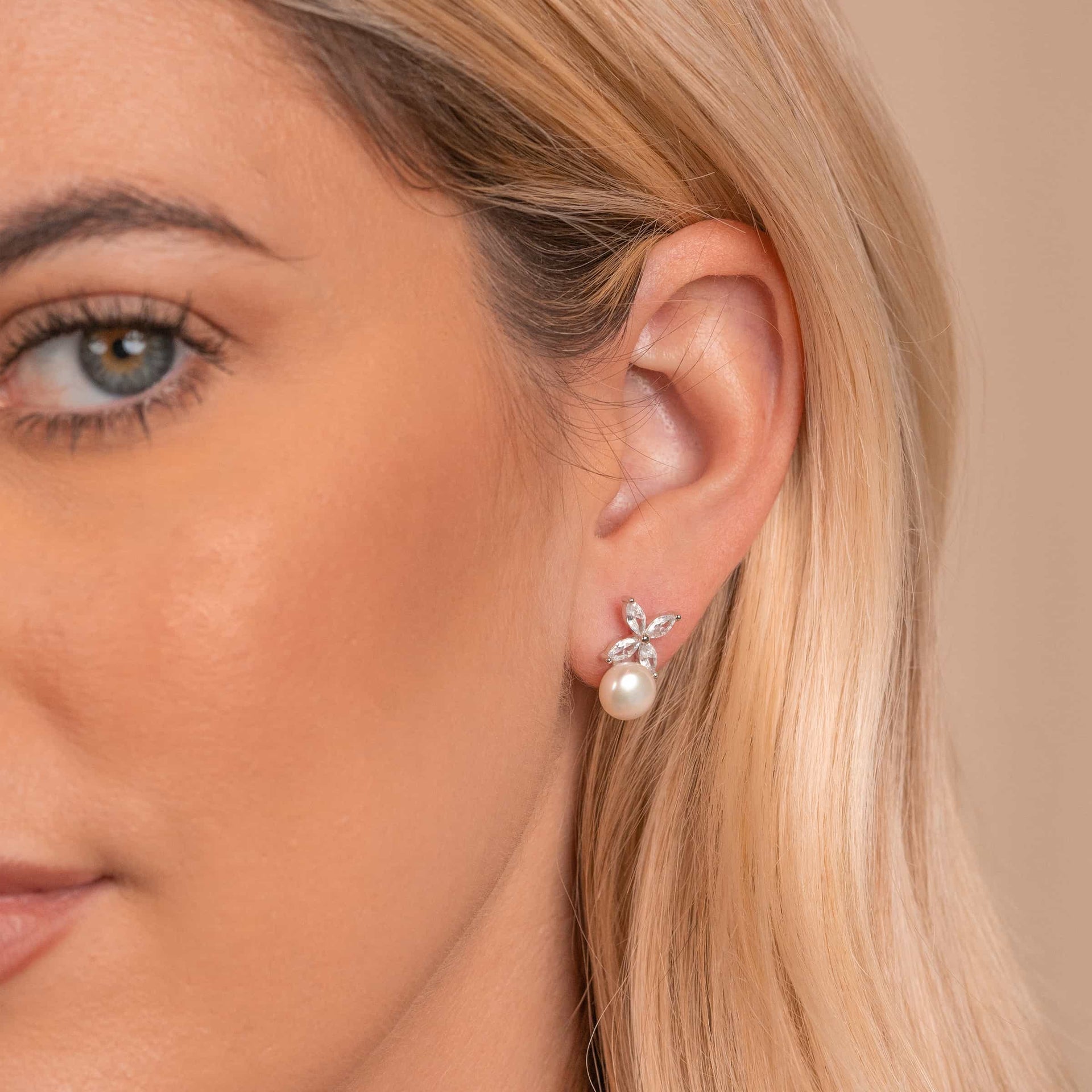 Woman wearing silver pearl earrings