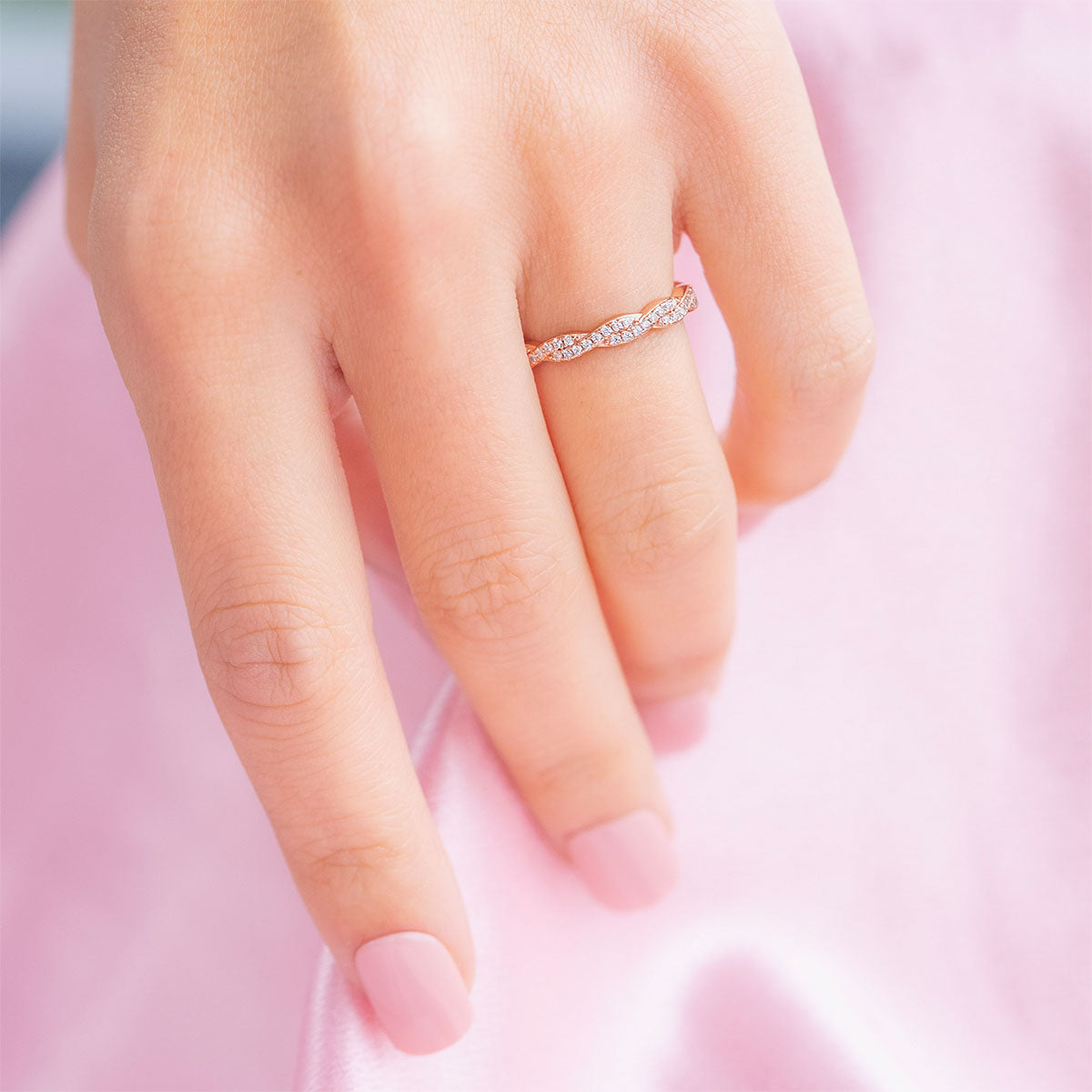 Woman wearing rose gold twisted wedding band