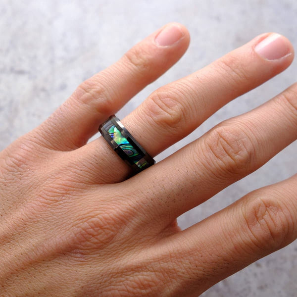 the voyager black tungsten wedding ring with abalone inlay on hand