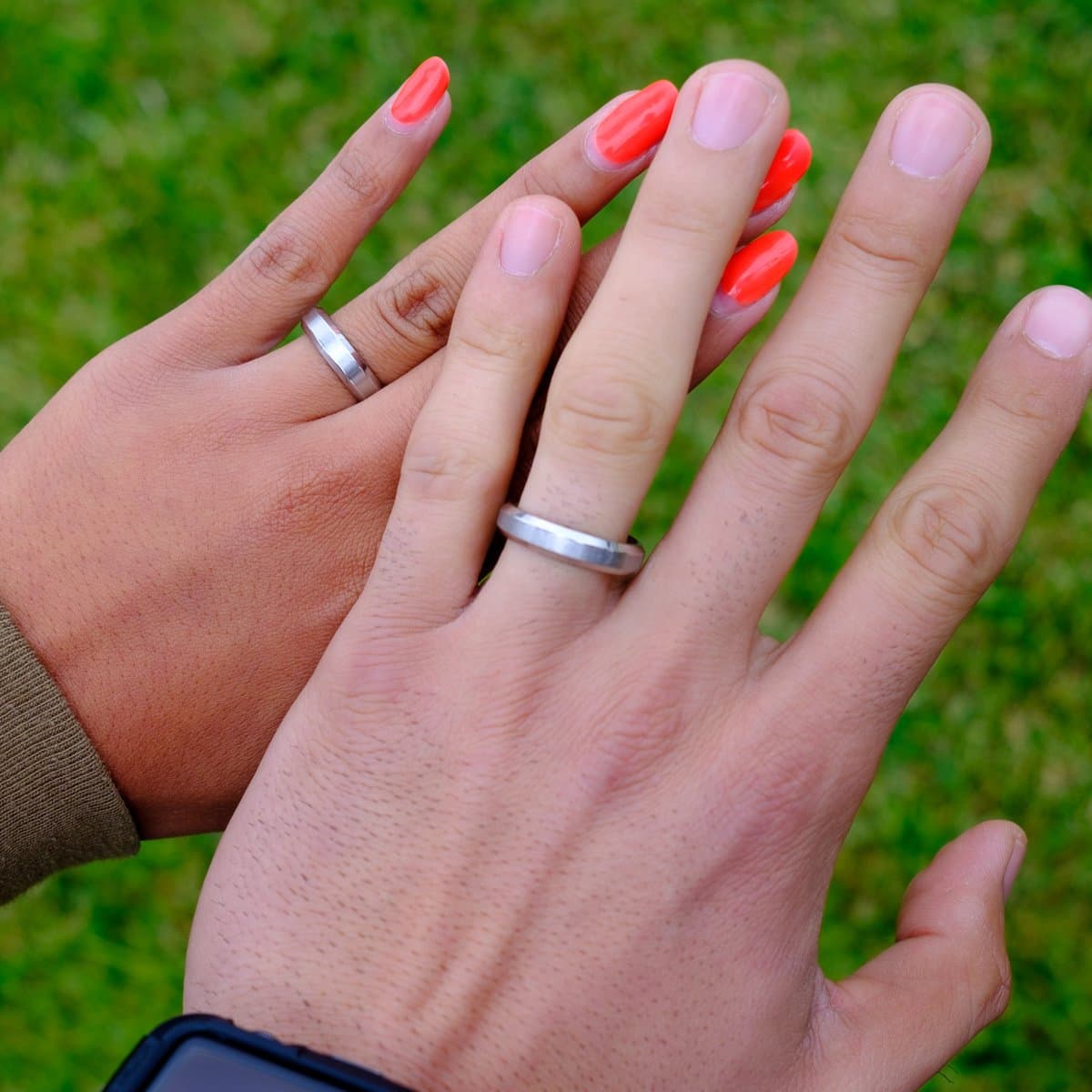 couples wearing silver infinity wedding ring