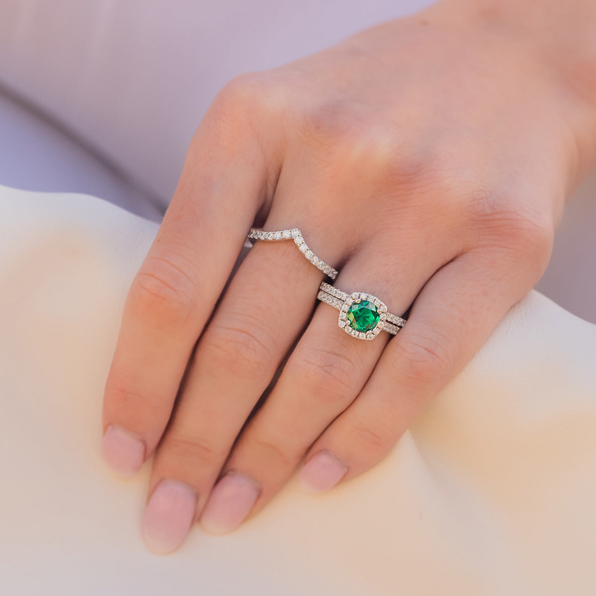 girls hand with emerald wedding ring