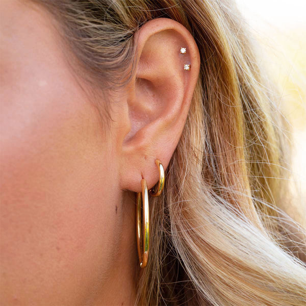 Gold hoop earrings on woman