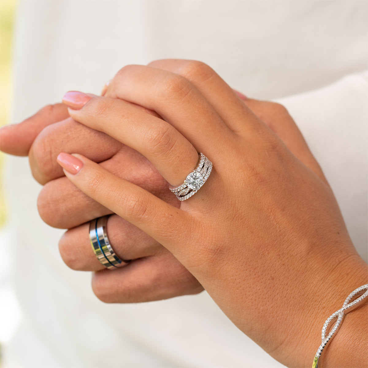 Couple wearing silver wedding rings