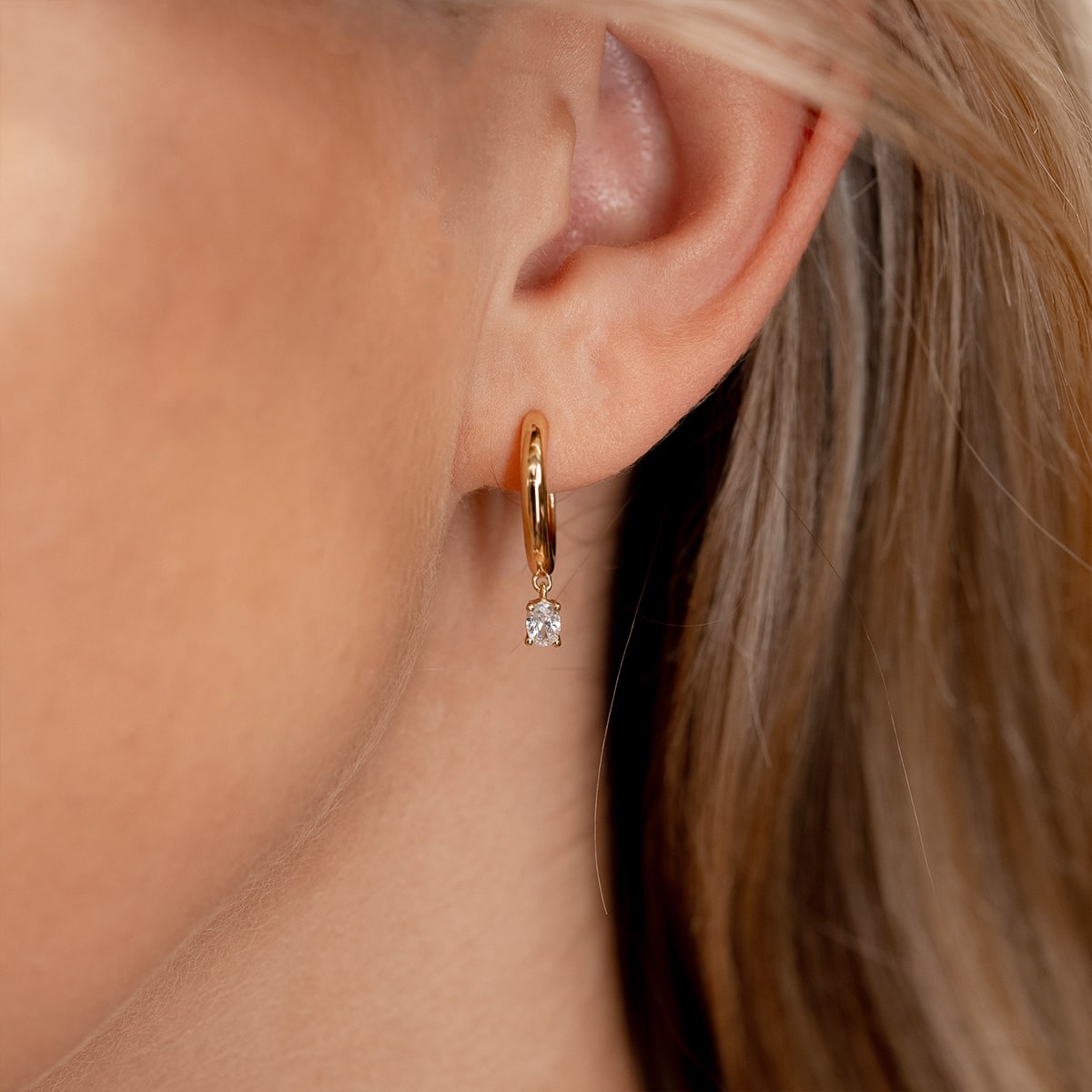 Woman wearing gold hoop earrings