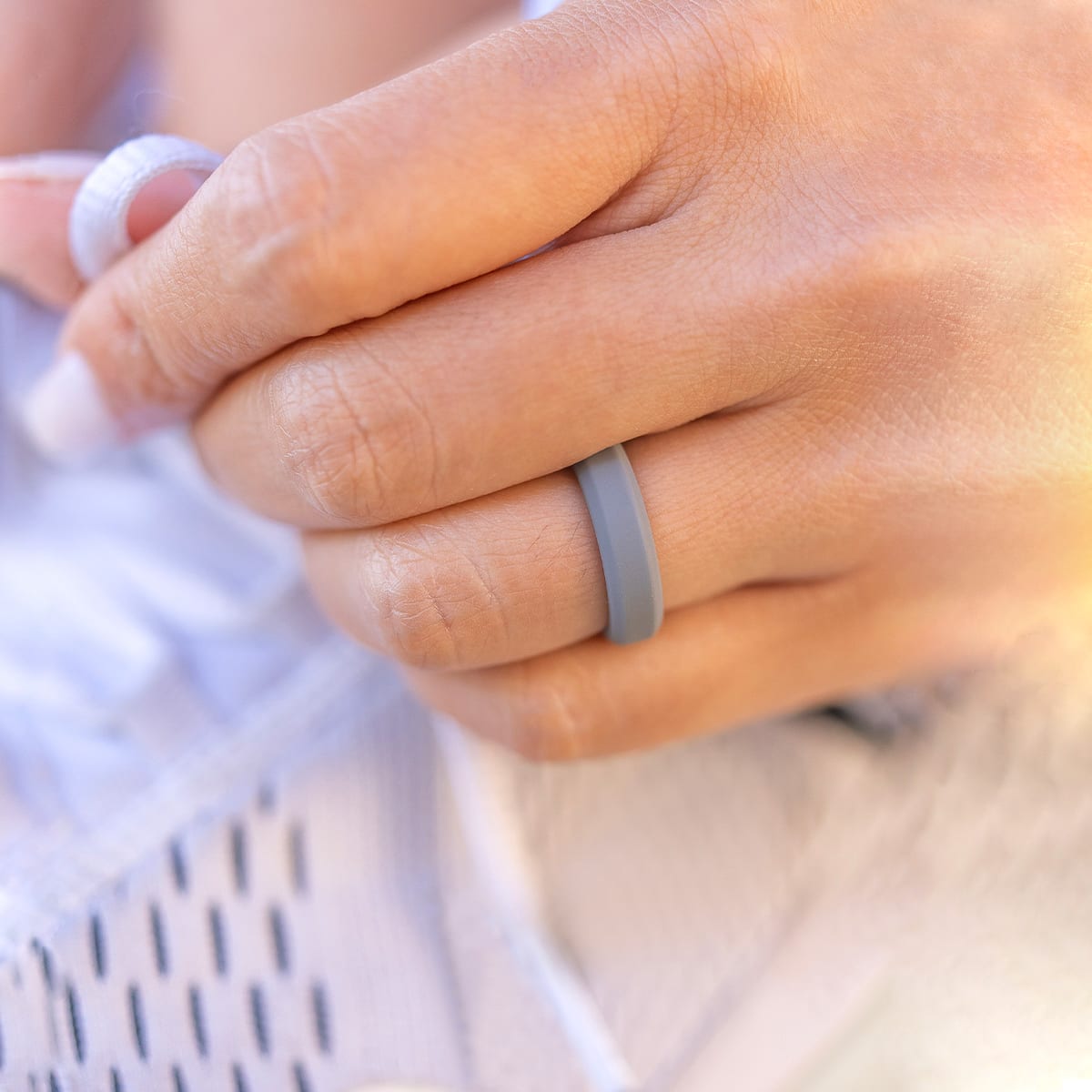 Woman wearing grey silicone wedding ring