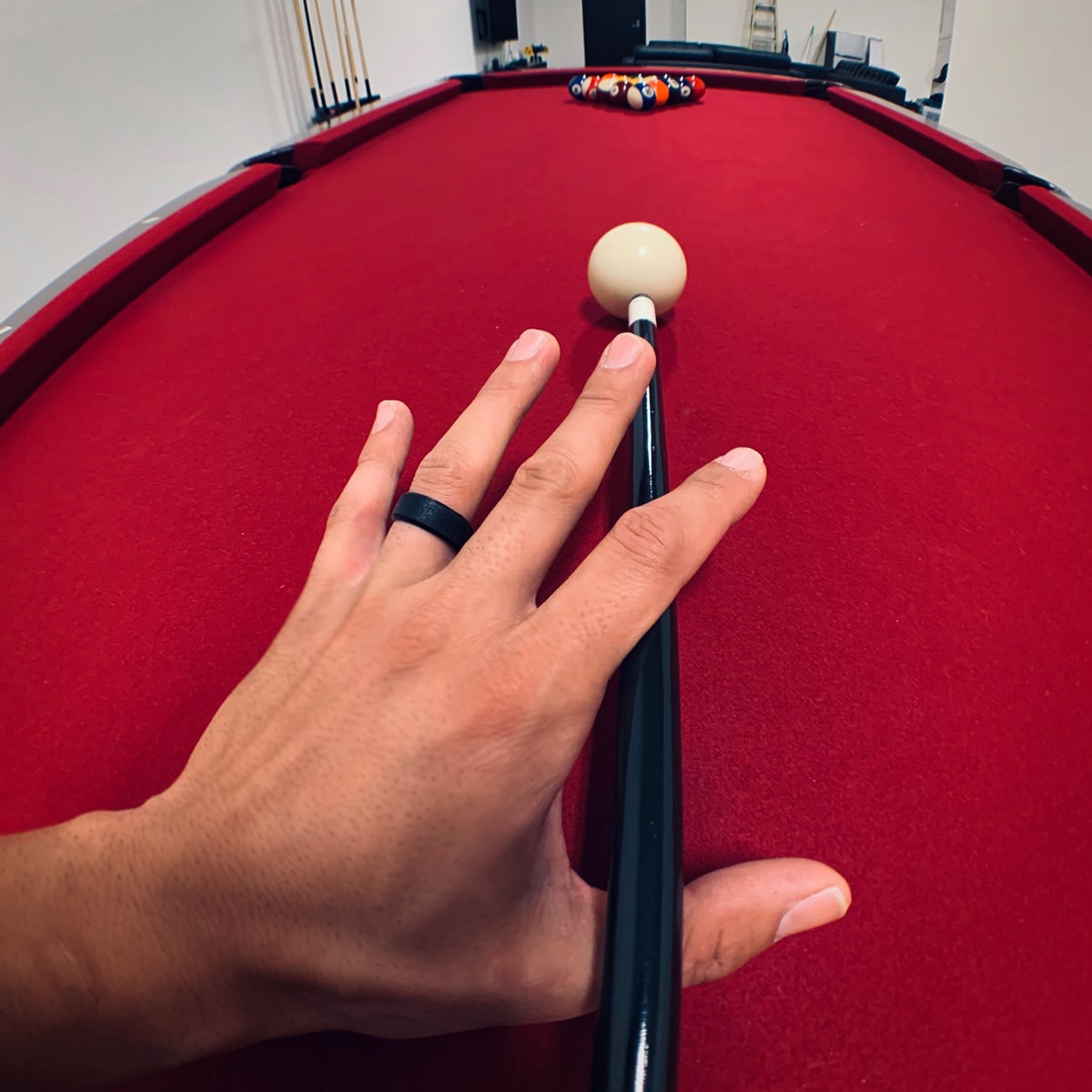 shooting pool with hand wearing force flex black wedding ring