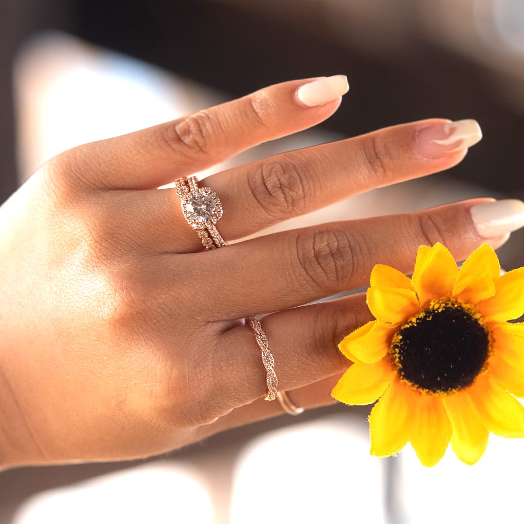 holding flower wearing wedding rings