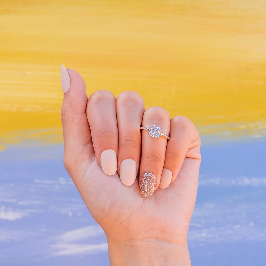 hand wearing rose gold engagement ring