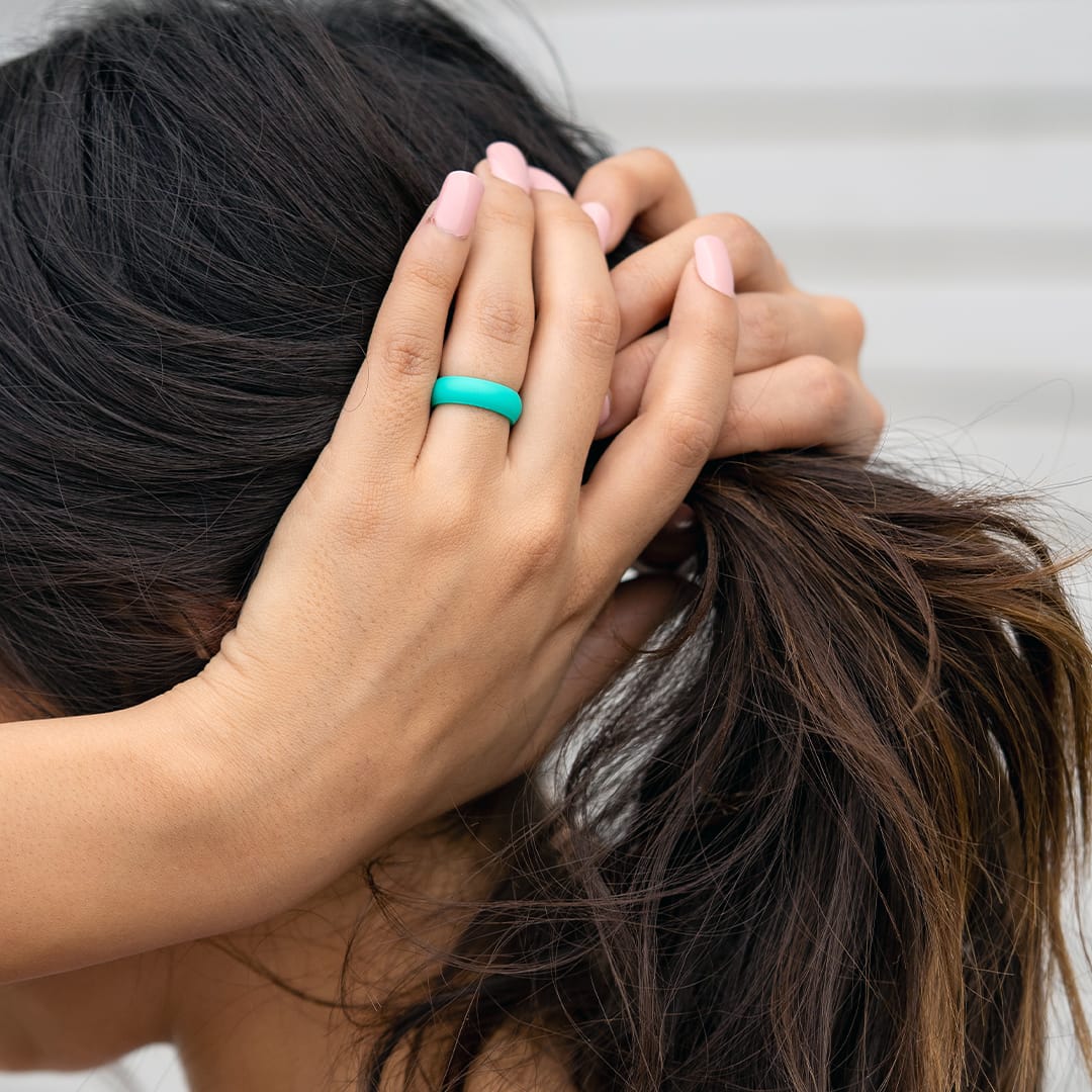 the flex teal silicone ring with girl tying up hair