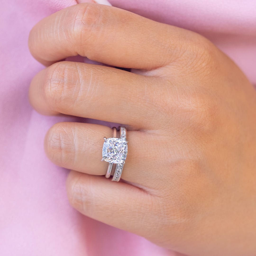 hand wearing silver wedding rings