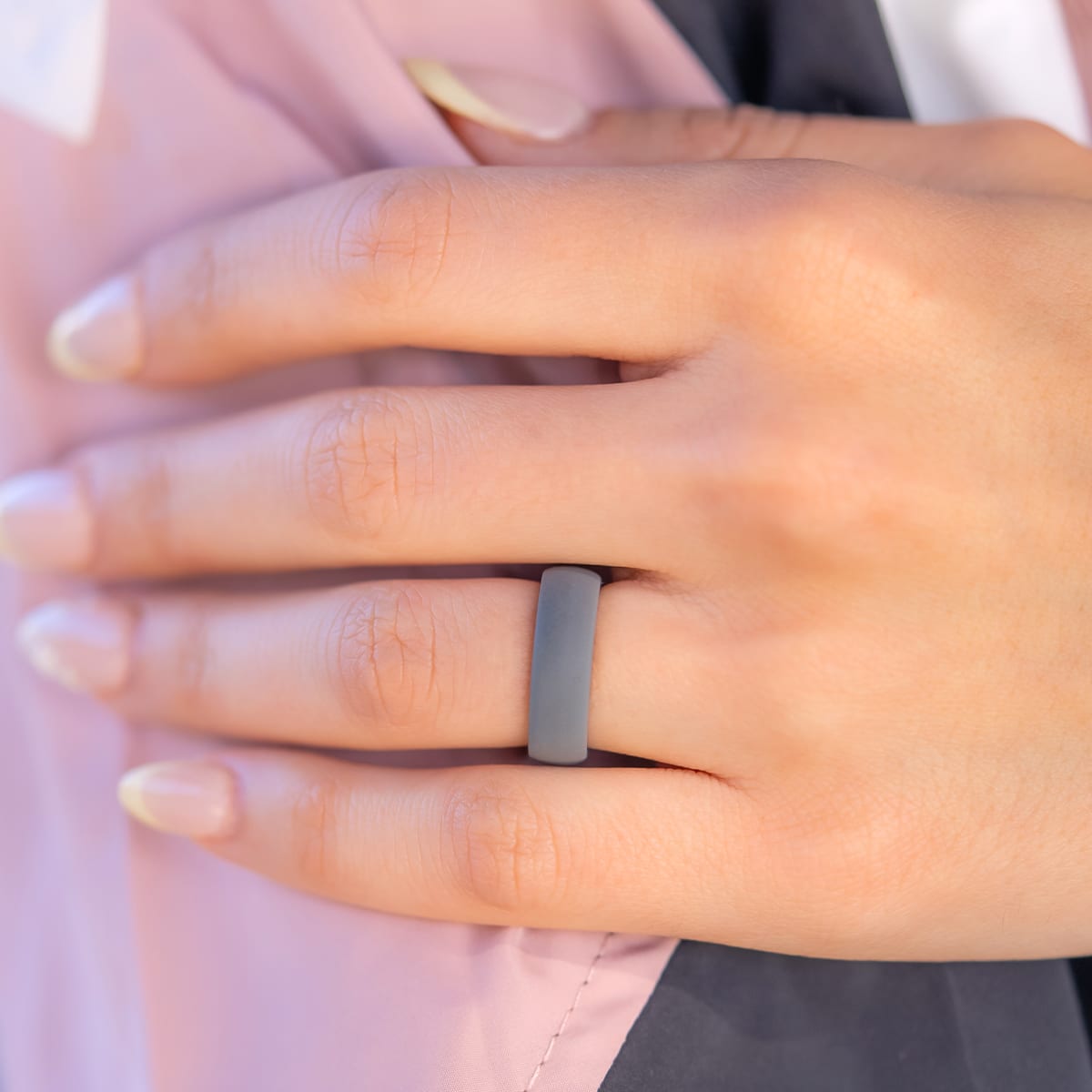 Gray silicone wedding band on a female hand