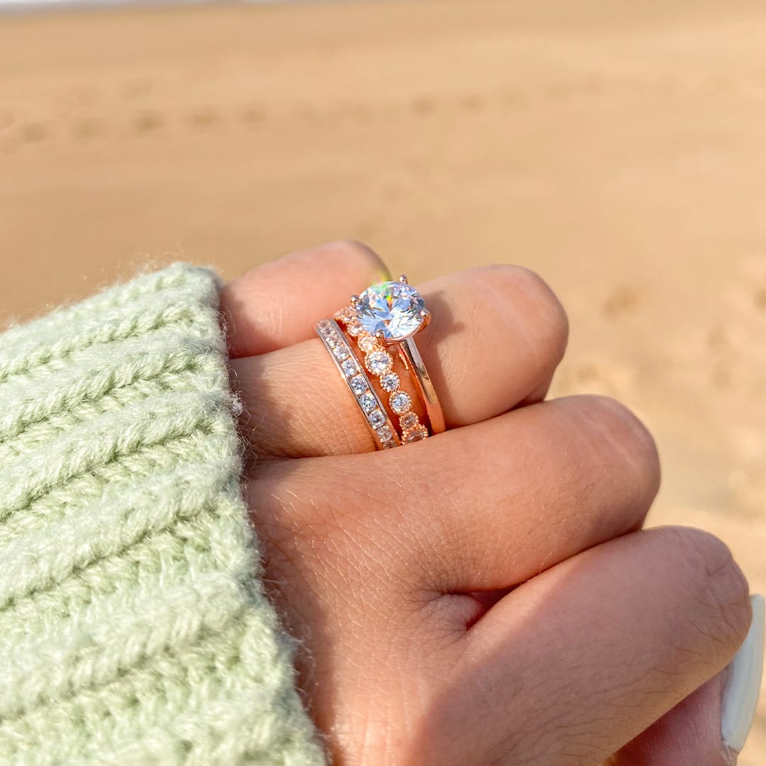 girl at beach with rose gold rings on