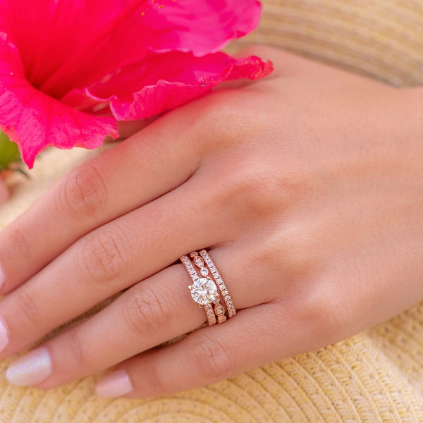 hand wearing rose gold wedding rings