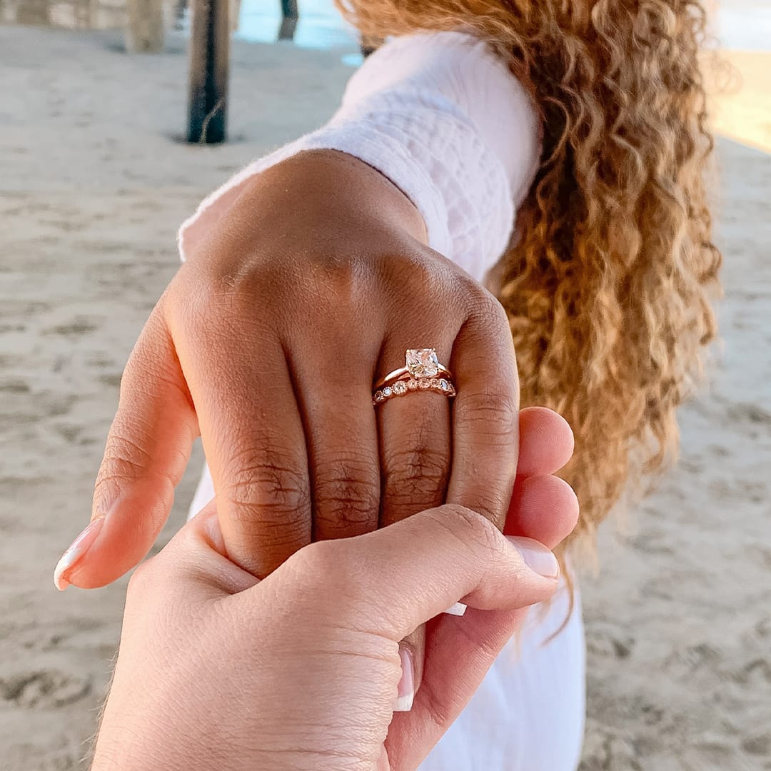 couple at beach wearing wedding rings